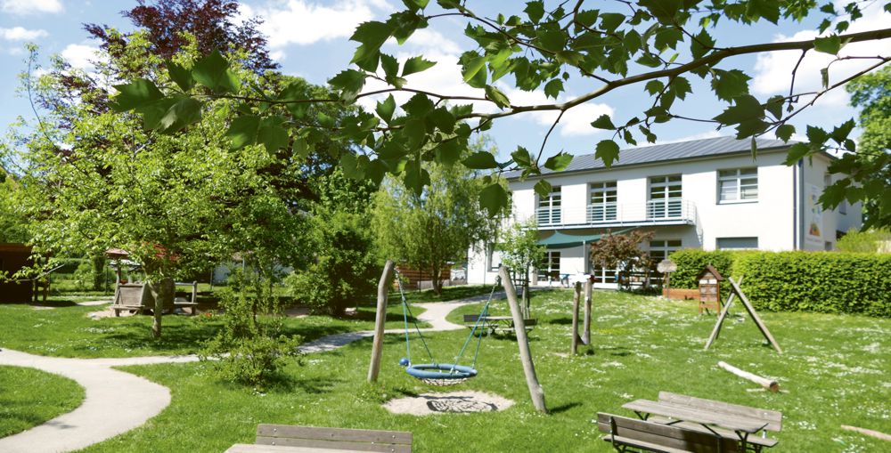Garten Kita Großpösna mit Schaukel und vielen Bäumen