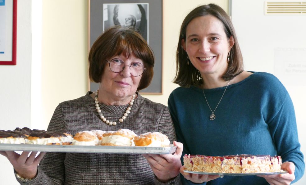 zwei strahlende Frauen mit Kuchenplatten